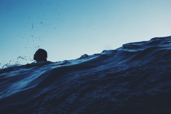 silhouette photography of person on body of water